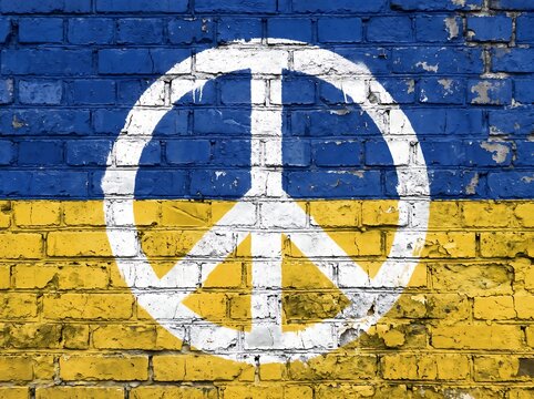 White peace symbol painted on a brick wall with blue and yellow ukraine flag colors