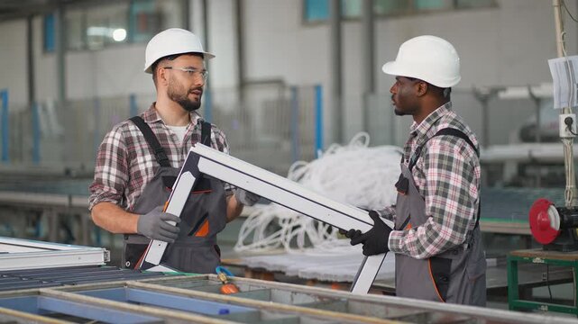 Diverse factory workers manufacturing pvc window frames