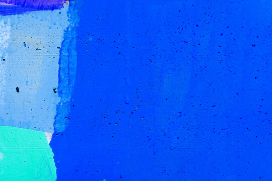 Abstract blue wall background with brush strokes in light blue, teal green colors