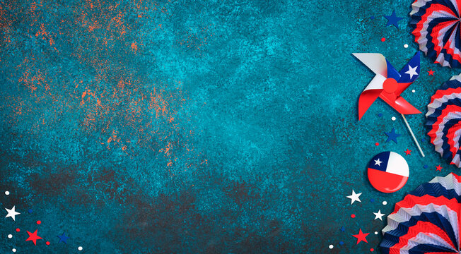 Chilean patriotic decorations placed on a grunge blue background with copy space