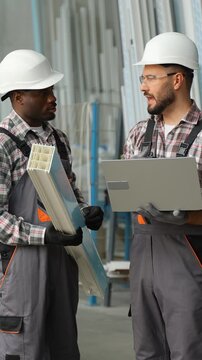 Factory workers discussing pvc window profile production