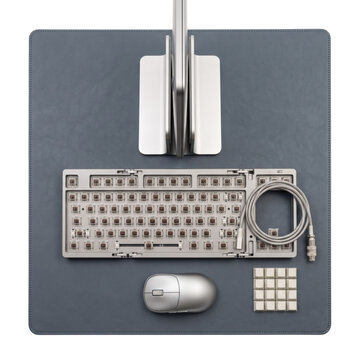 Minimalist desk setup with keyboard and mouse on leather mat