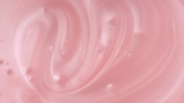 Liquid pink washing gel texture, soap, shampoo. Pearlescent surface of liquid pink fluid, background, shampoo texture, body care cosmetic, soap backdrop with bubbles top view, from above, rotating 