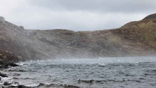 Storm flings up water spray on Devil's Punchbowl lake in  Killarney National Park, Ireland