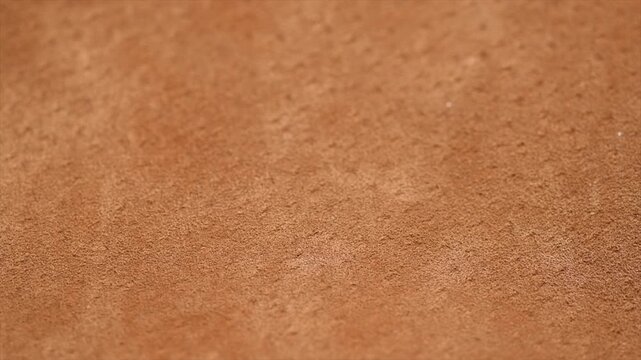 Suede texture background close up. Brown suede leather surface backdrop, genuine leather, top view. Suede of animal skin. Texture for design. Rotating background.