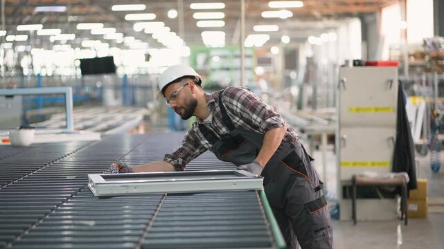 Factory worker assembling pvc window frame