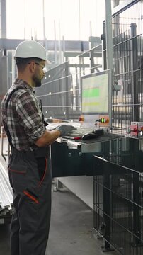 Industrial engineer operating cnc machinery in a modern factory