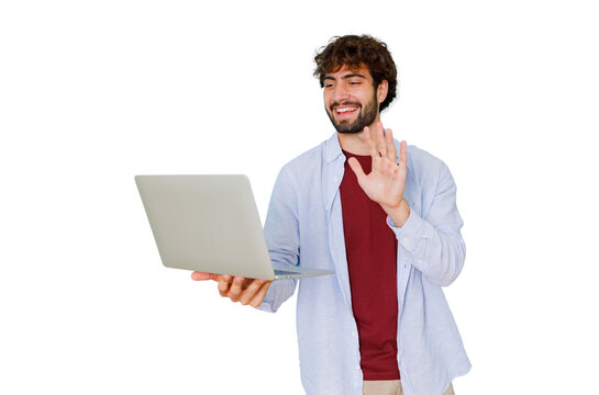 Young man smiling and waving during a video call on laptop representing remote communication and virtual greetings
