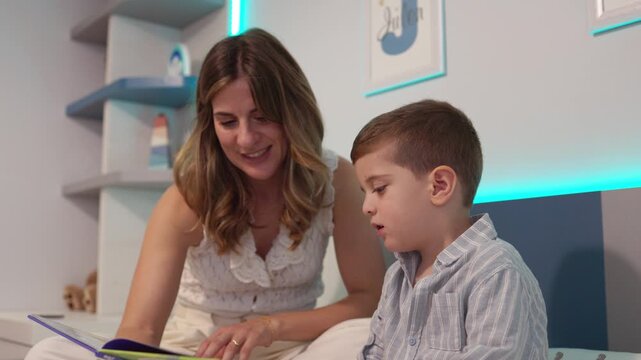 Mother reading a bedtime story to her son in the bedroom