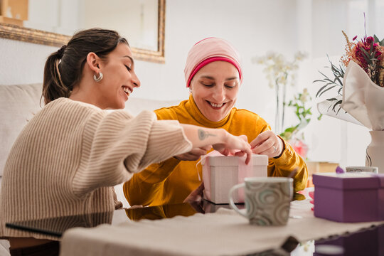 Mother and daughter opening gifts celebrating cancer recovery