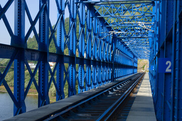Naklejka premium Steel Lattice Railway Bridge Truss and Train Tracks Crossing River