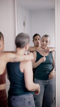 Cancer survivor mother and daughter getting ready together