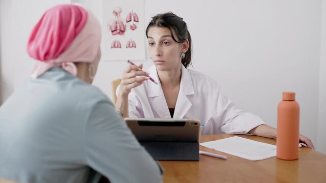 Young doctor prescribing medicine to cancer patient