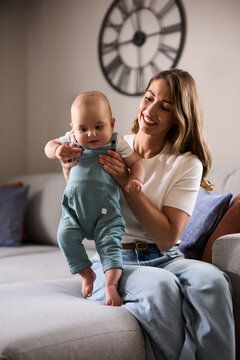 Happy mother enjoying in time with her baby boy at home.