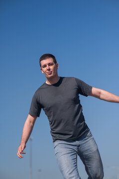 A Caucasian man rollerblades around the slalom course.