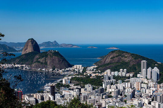 The panoramic photo of Rio de Janeiro reveals hills, sea, bay, and city in sweeping layers, highlighting the geography. Rio de Janeiro, Brazil.