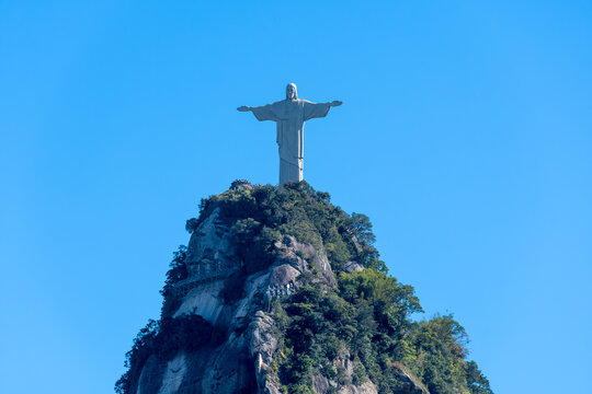 Christ the Redeemer towers over the summit of Corcovado with open arms. Rio de Janeiro, Brazil.