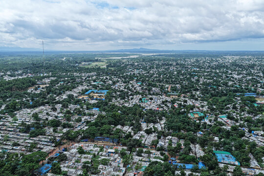 Aerial view of Kutupalang Camp 7 with dense rows of shelters, lush green trees, and pathways in Cox's Bazar District, Chittagong Division, Bangladesh.
