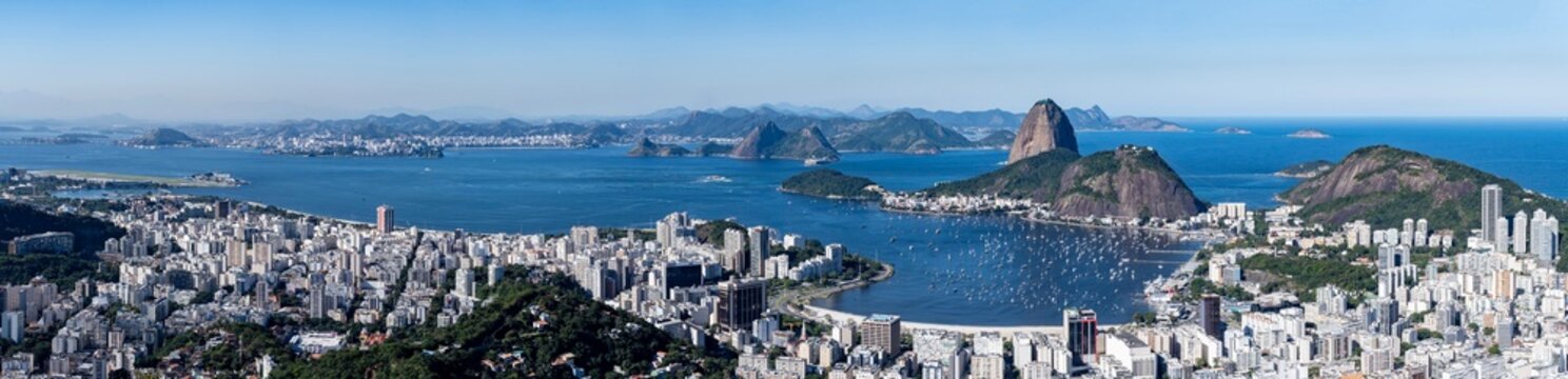 The panoramic photo of Rio de Janeiro reveals hills, sea, bay, and city in sweeping layers, highlighting the geography. Rio de Janeiro, Brazil.