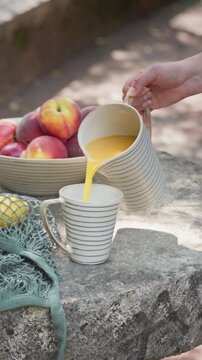 Pouring Fresh Juice into a Mug