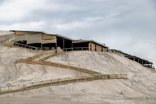Modern protective canopy and zigzagging ramp with railings leading up the sandy mound of Huaca Cao Viejo at the El Brujo archaeological complex in Peru
