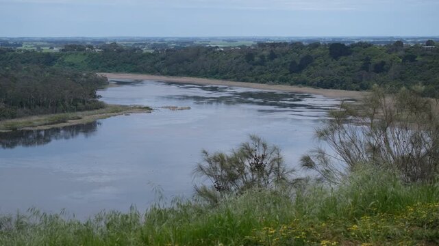 An elevated, panoramic view of Tower Hill Lake within the ancient nested maar volcanic crater near Koroit and Warrnambool, Victoria, Australia.&nbsp;Forested crater walls and distant rolling plains.
