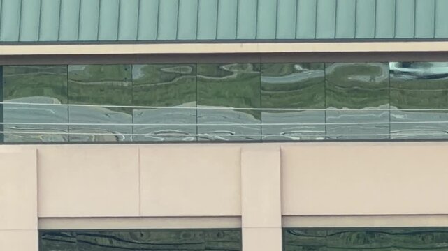 Cars reflection driving by on windows 