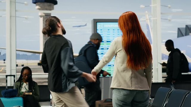 A boyfriend falls during an emotional airport farewell as he separates from his girlfriend and leaves for relocation abroad, capturing bittersweet parting.