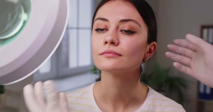 Patient consults a plastic surgeon or doctor before a beauty procedure, discussing skin care and surgery options. Medical advice, cosmetic treatment, and expert healthcare appointment.
