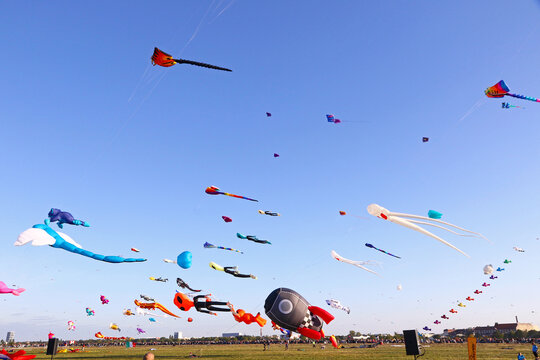 Berlin, Germany - September 27, 2025: Giant kites fill the sky above Tempelhofer Feld during the annual Festival der Riesendrachen, one of Berlin's most popular outdoor autumn events