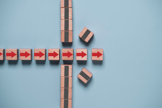 Breaking through business obstacles concept with a red arrow passing through a gray barrier, symbolizing overcoming challenges, business growth, resilience, strategic success, and forward progress.