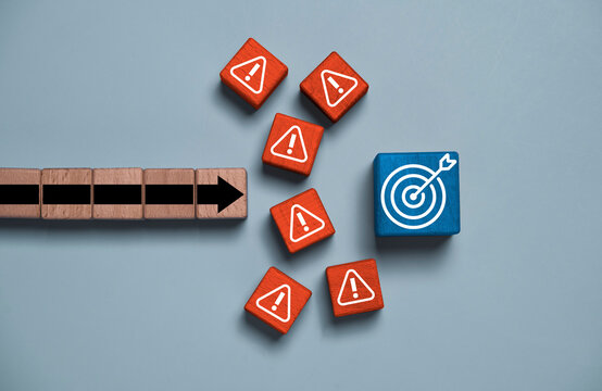 Achieve business goals concept with an arrow moving toward a target while facing warning signs for business challenges, obstacles, risk management, problem solving, resilience and strategic planning.
