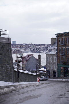 Cote de la Montagne street in Quebec city, canada with St. Lawrence river in winter