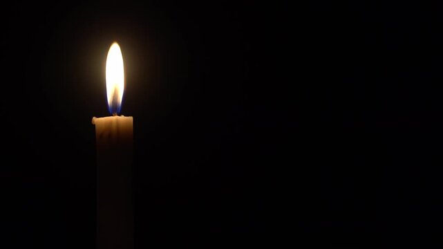 Single Candle Burning and Waving in the Dark with Copy Space