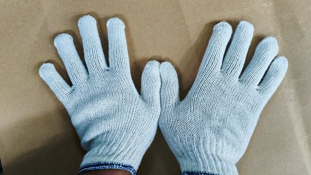 ​White Safety Working Gloves on Brown Background