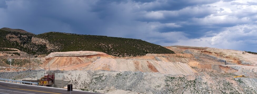 Panorama of a mine entrance and tailings by the side of the road