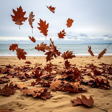 Autumn leaves scattered on sandy beach with ocean backdrop.