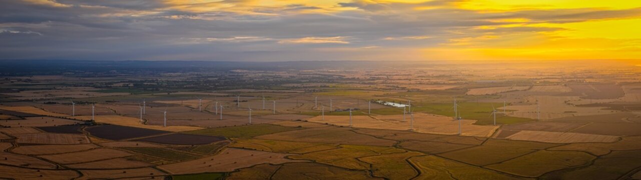 Sussex Wind Turbines at Fiery Sunset Across Rural England Countryside View