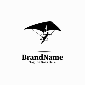 Clean black vector icon of a hang glider pilot gliding through the air, extreme air sports logo on white background