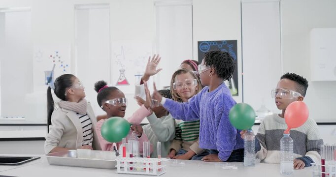 Instructor guiding kids using test tubes filling bottles at bench inflating balloons studying gas