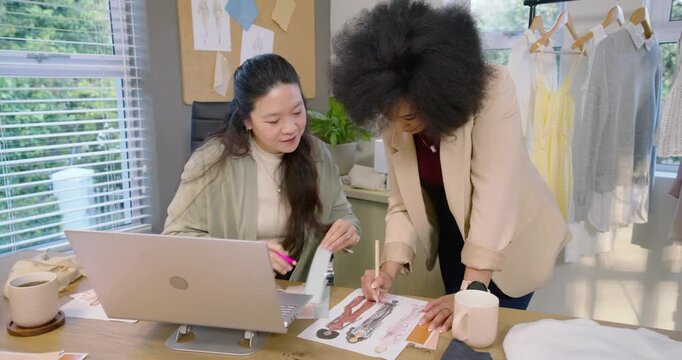 African American Asian women opening swatches, matching to sketches, deciding details in studio