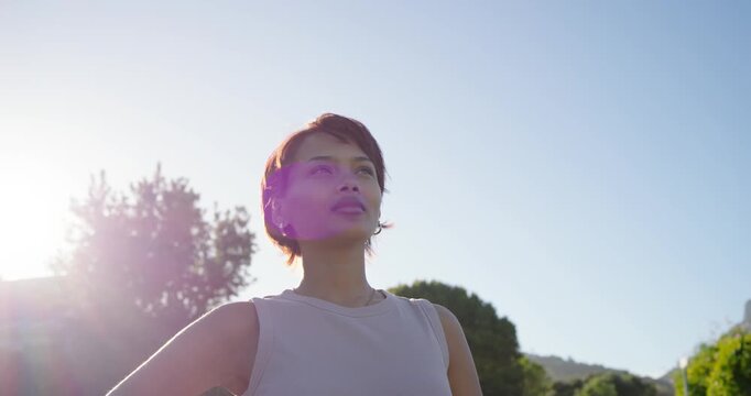 African American woman posing in park with hoops sun flaring left turning reacting smiling laughing