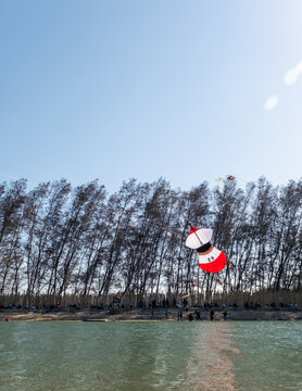 Kite flyers are carefully preparing to launch their kites, working together at Mertasari Beach, Sanur, Denpasar, Bali, on July 25, 2026.