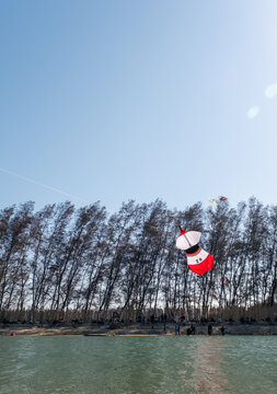 Kite flyers are carefully preparing to launch their kites, working together at Mertasari Beach, Sanur, Denpasar, Bali, on July 25, 2026.