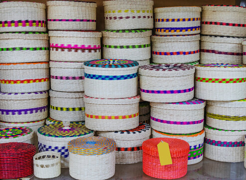 On display are colorful, handcrafted cylindrical baskets made from eco-friendly paja toquilla straw, a plant fiber, famous souvenir from Ecuador