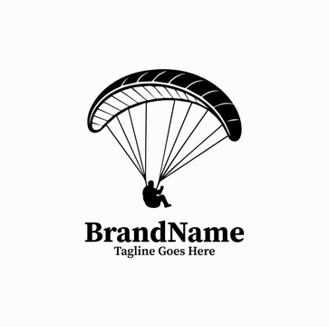 Dynamic black vector logo of a paraglider flying with open parachute, extreme air sports icon isolated on white background