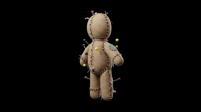 A detailed close-up of a burlap voodoo doll, seen from behind, with several colorful pins stuck into its fabric body. The intricate stitching and patches are clearly visible against the solid black ba
