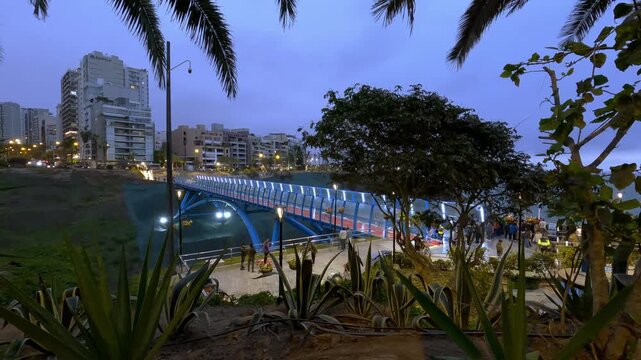 Puente de la Paz, a famous bridge in Lima, Peru: a time-lapse of people crossing the illuminated bridge at night.