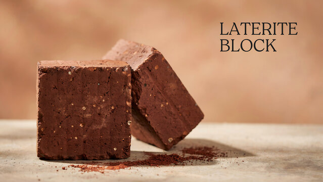 Two rough textured laterite blocks placed on flat surface with natural lighting