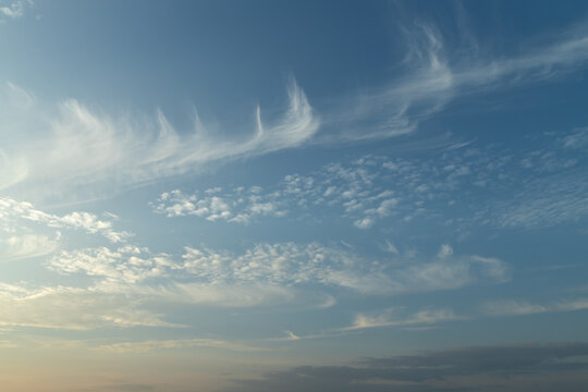 Full frame abstract texture cloudscape consisting of a combination of cirrus and cirrocumulus clouds in the sky near sunset or sunrise hours
